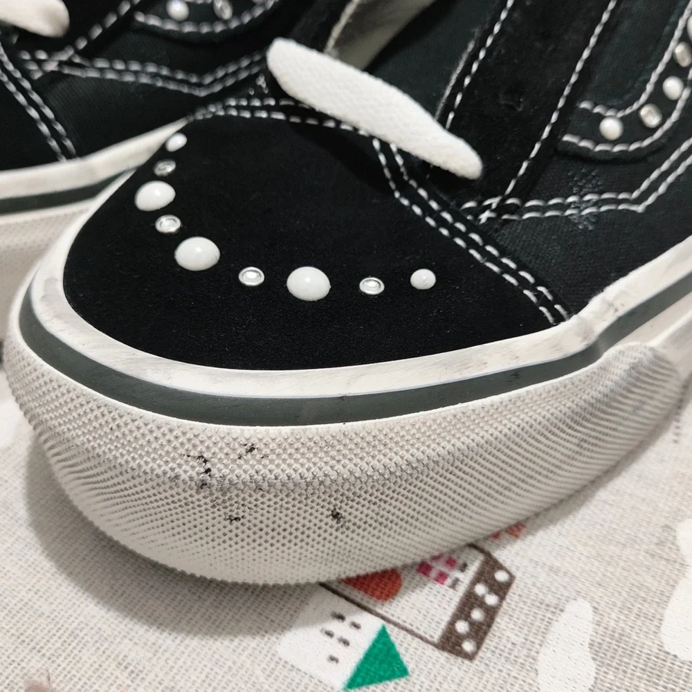 Vans Black Canvas Slip-On Sneakers with Maroon Lining and White Stud Detail
